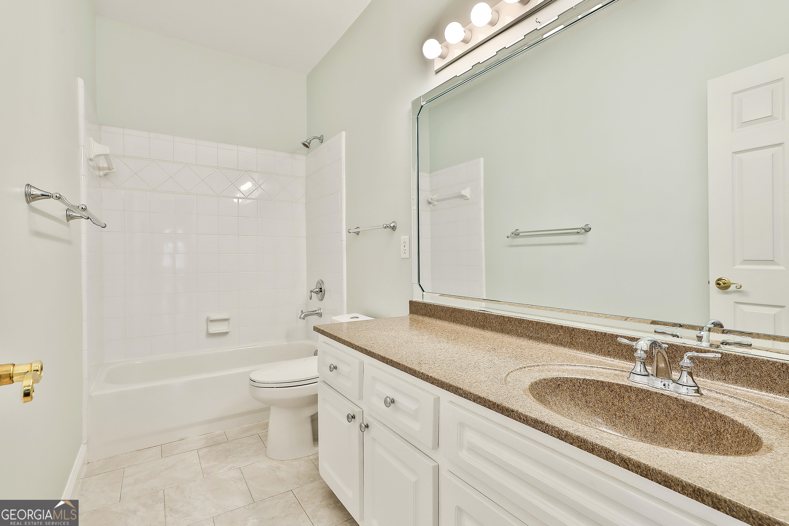 207 Prestwick Way North Stockbridge, GA 30281 - Photo 32 of 44 a bathroom with a granite countertop sink a toilet a shower and a mirror