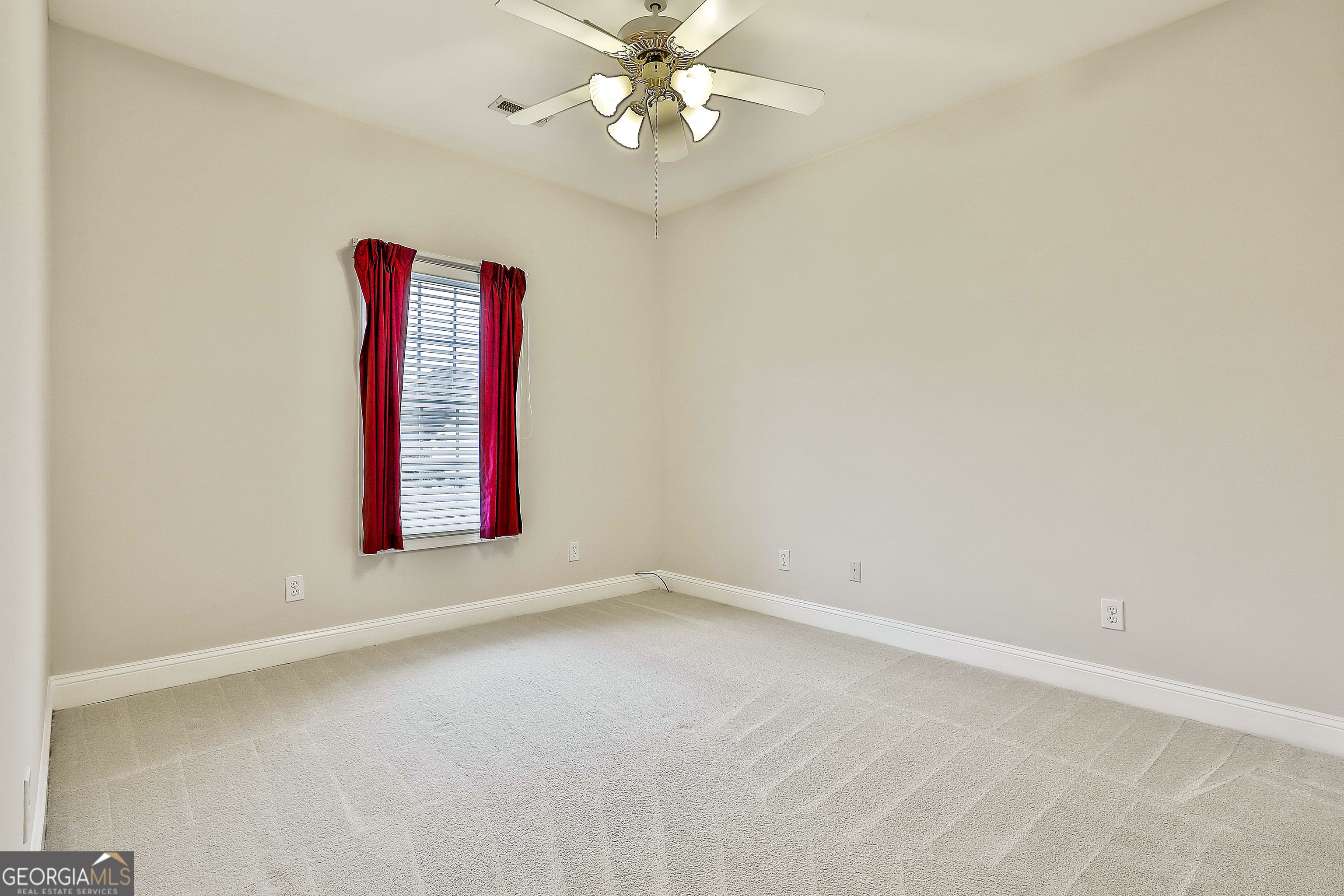 207 Prestwick Way North Stockbridge, GA 30281 - Photo 33 of 44 an empty room with windows and fan