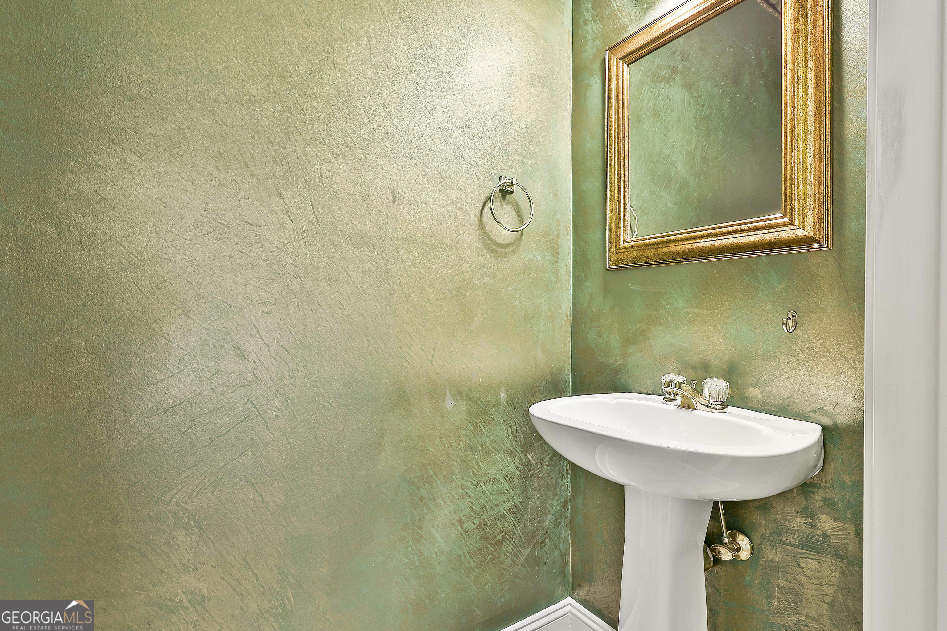 207 Prestwick Way North Stockbridge, GA 30281 - Photo 34 of 44 a bathroom with a sink a mirror and a shower