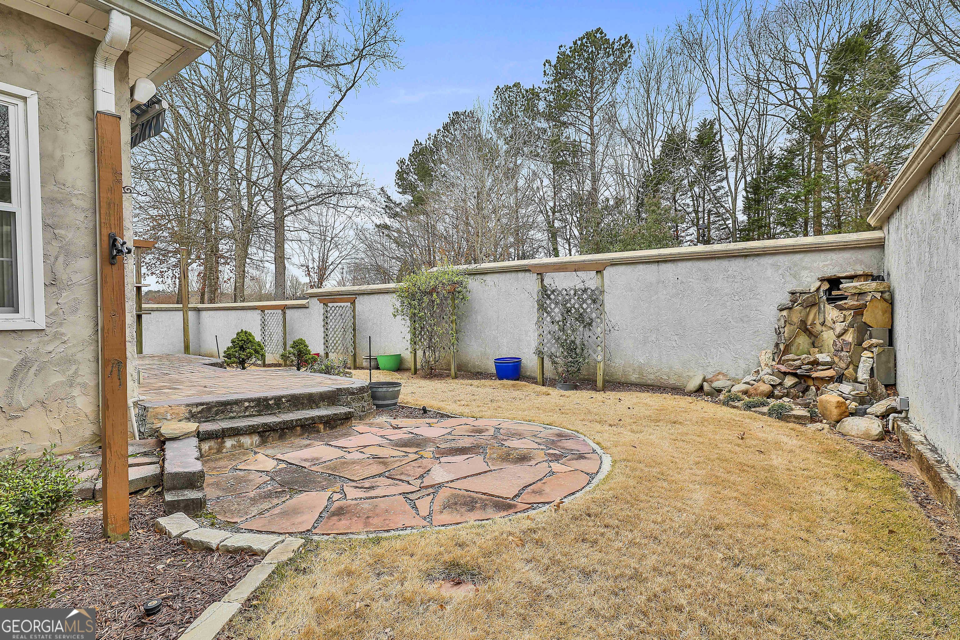 207 Prestwick Way North Stockbridge, GA 30281 - Photo 38 of 44 a backyard of a house with barbeque oven table and chairs