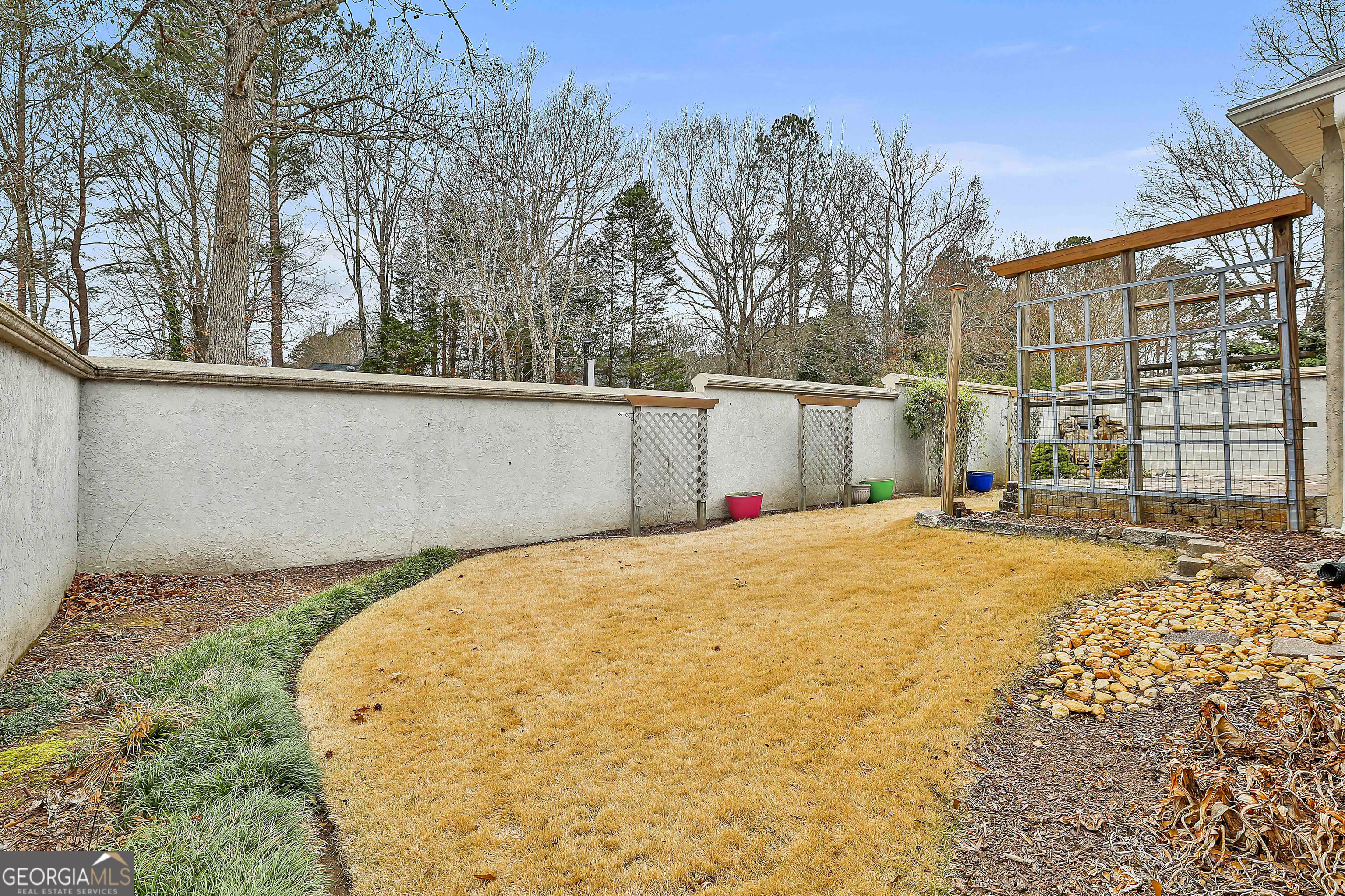 207 Prestwick Way North Stockbridge, GA 30281 - Photo 41 of 44 a view of backyard with large trees and wooden fence