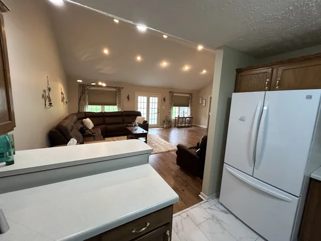 a kitchen with a refrigerator and a stove top oven