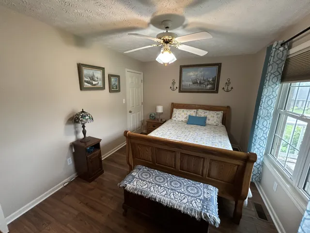 a bedroom with a bed and a mirror