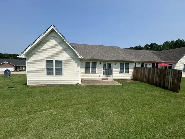 a front view of a house with yard porch and furniture