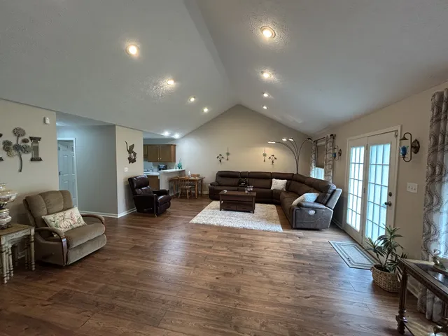 a living room with furniture window and wooden floor