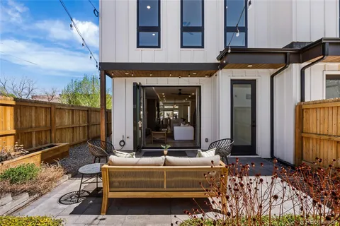 a view of a chair and table in the back yard of the house