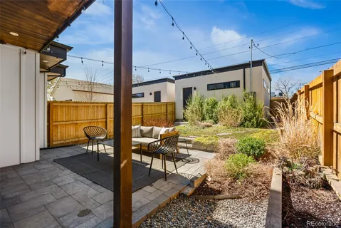 a view of patio with table and chairs and potted plants