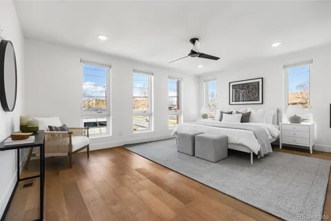 a spacious bedroom with a bed couch and a window