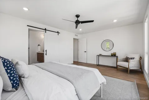 a bedroom with a bed and a chandelier