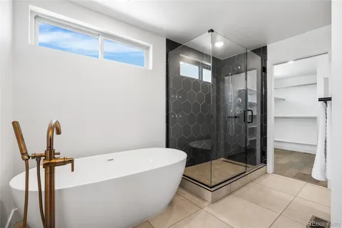 a bathroom with a tub and shower