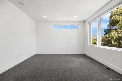 an empty room with windows and closet