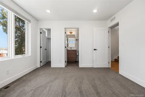 a bathroom with a granite countertop toilet sink and shower
