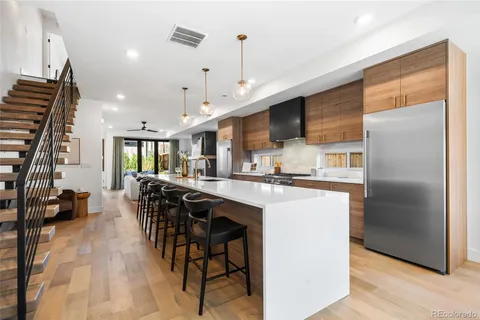 a kitchen with stainless steel appliances kitchen island a refrigerator and a stove top oven