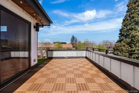 a view of balcony with wooden floor and city view