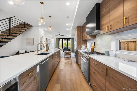 a large kitchen with stainless steel appliances kitchen island a large counter space a sink and cabinets