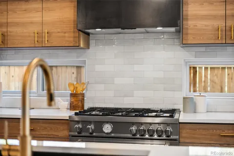 a stove top oven sitting inside of a kitchen