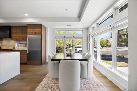 a living room with stainless steel appliances granite countertop furniture and a large window