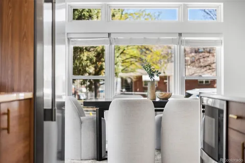 a dining room with furniture and a window