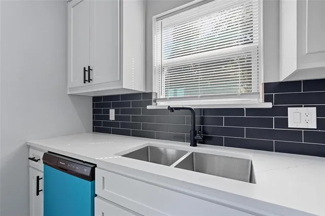 a kitchen that has a sink and a window