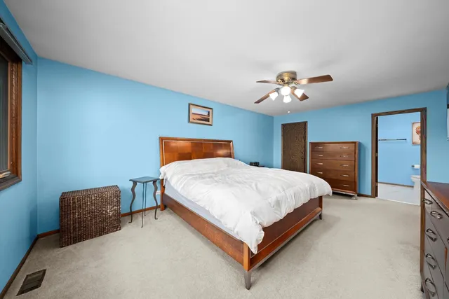 a bedroom with bed and a chandelier