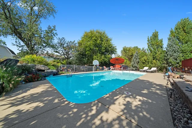 a view of a backyard with swimming pool