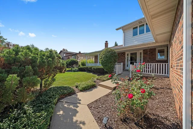 a view of a house with a yard and garden