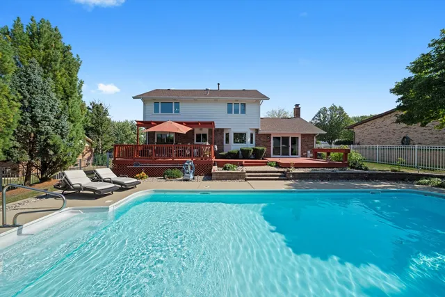 a view of a house with swimming pool and porch