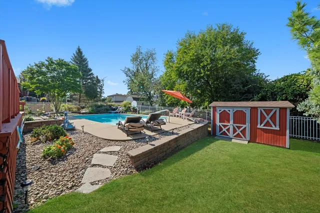 a view of a chairs and fire pit in the grass