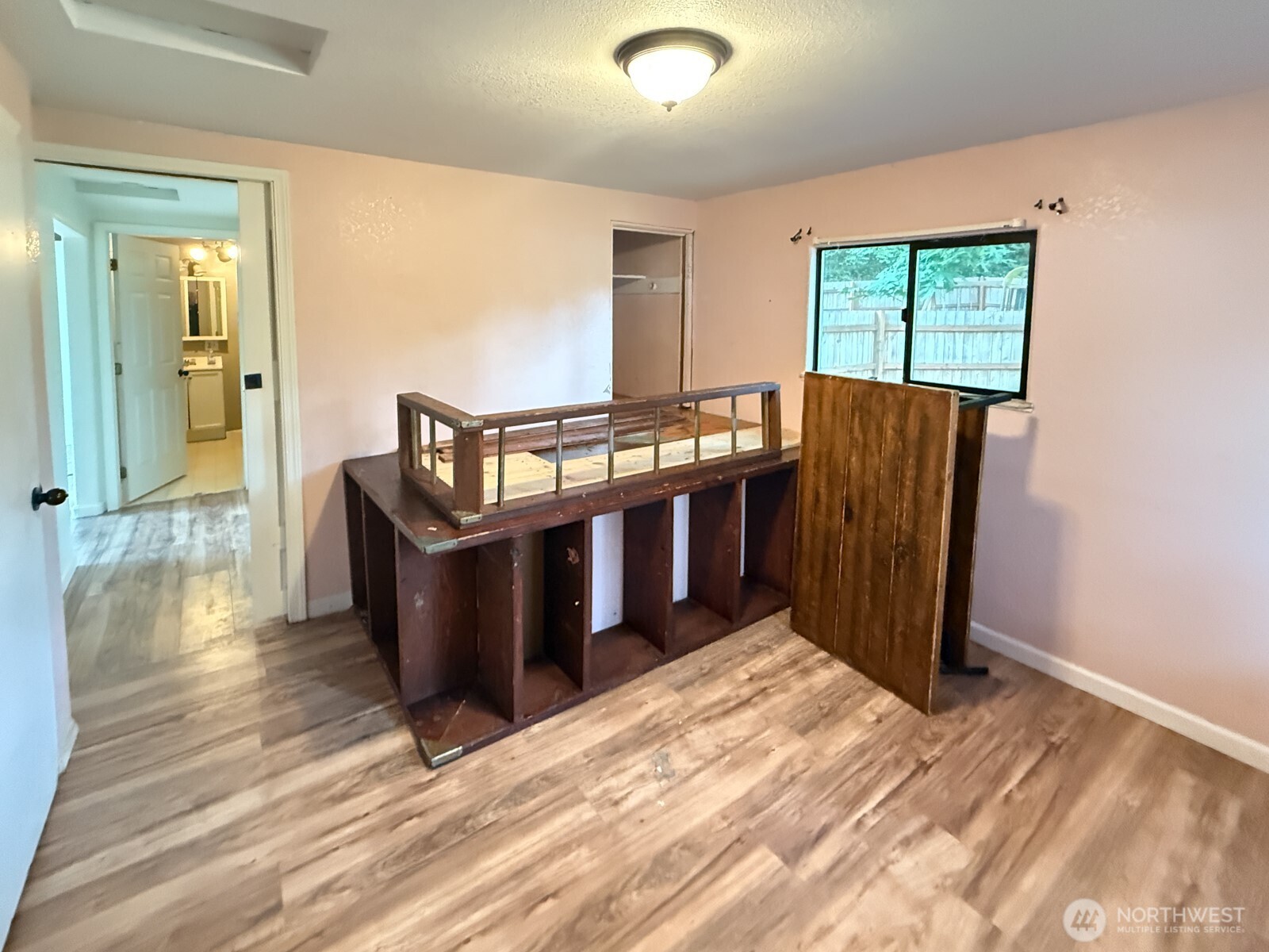 701 Northwest Dexter Avenue Winlock, WA 98596 - Photo 18 of 26 a view of a bedroom with wooden floor and windows
