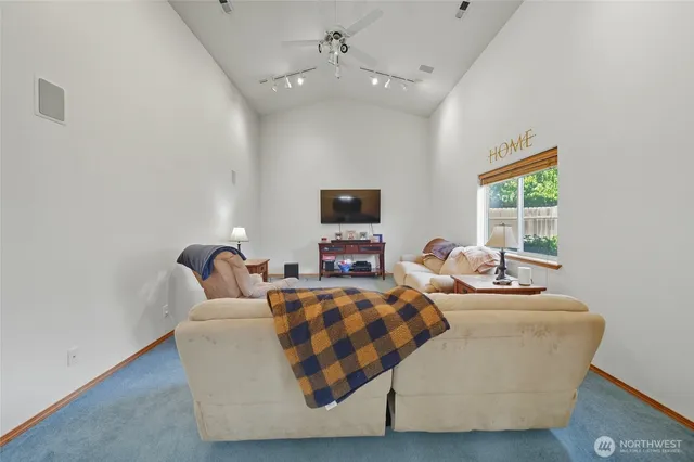 a living room with fireplace furniture and a window