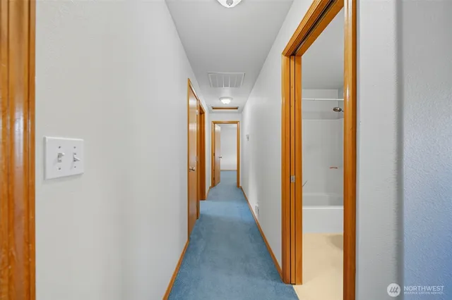 a view of a hallway with a wooden floor