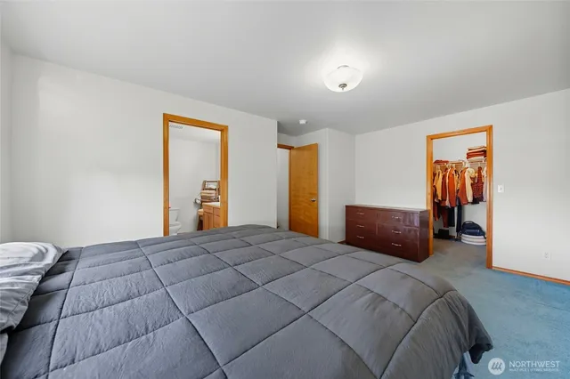 a bedroom with a bed and dresser