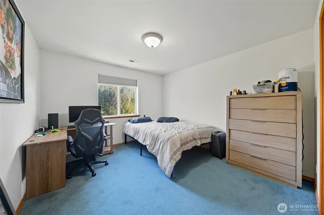 a bed room with a bed and a desk