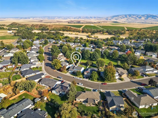 an aerial view of residential houses with outdoor space