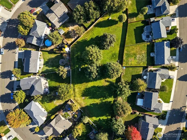 an aerial view of residential houses with outdoor space