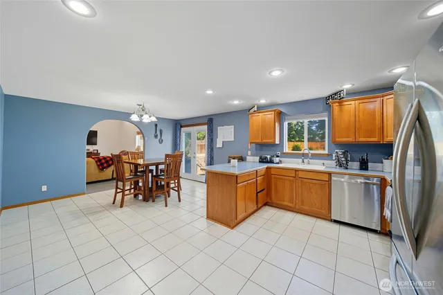 a kitchen with stainless steel appliances granite countertop a refrigerator and microwave