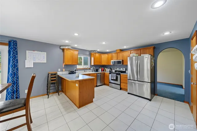 a kitchen with stainless steel appliances granite countertop a refrigerator and a stove