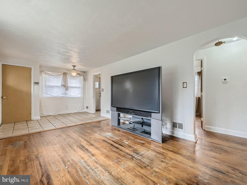 4816 Valley Forge Road Randallstown, MD 21133 - Photo 11 of 11 a view of a livingroom with wooden floor and a flat screen tv