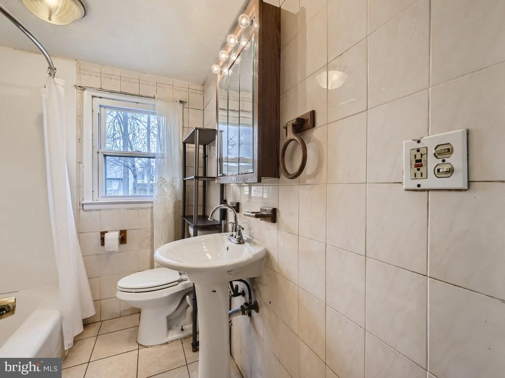 4816 Valley Forge Road Randallstown, MD 21133 - Photo 2 of 11 a bathroom with a sink toilet and shower