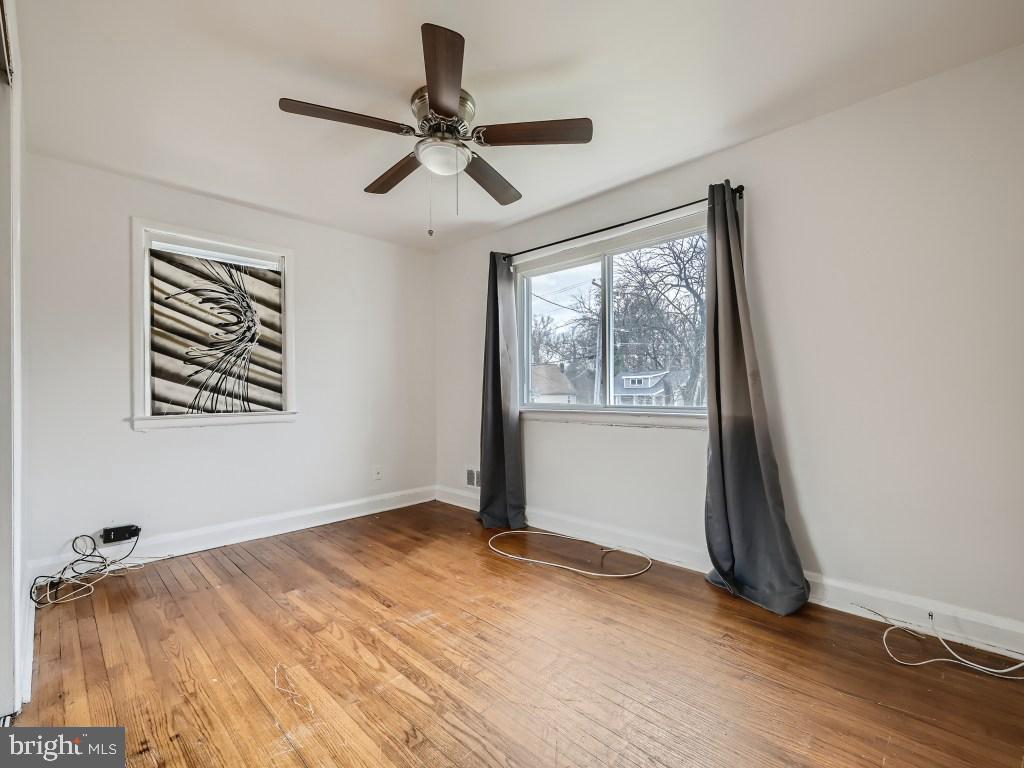 4816 Valley Forge Road Randallstown, MD 21133 - Photo 4 of 11 a view of empty room with wooden floor and fan