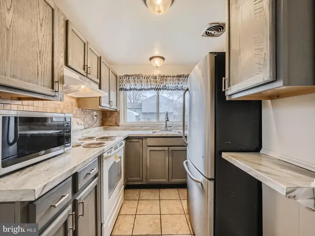 a kitchen with a stove microwave and a sink