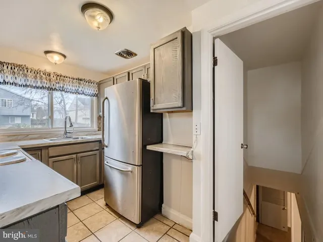 a kitchen with a refrigerator sink and stove