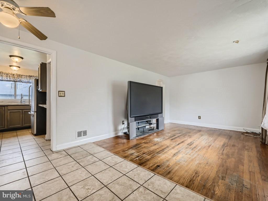 4816 Valley Forge Road Randallstown, MD 21133 - Photo 10 of 11 a bedroom with a bed and a flat tv screen on dresser