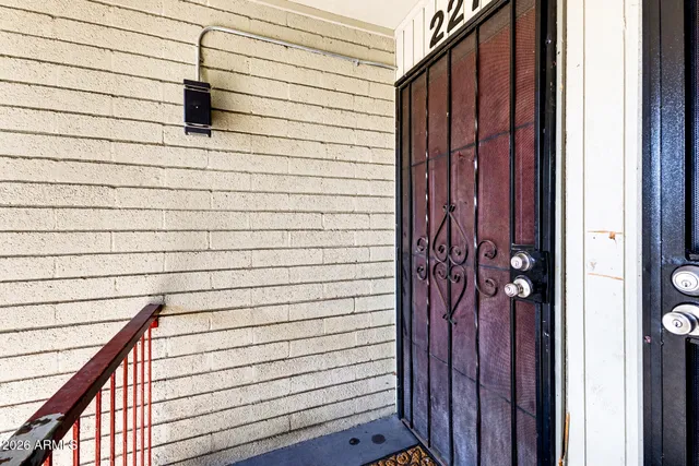 an empty room with wooden floor and glass door