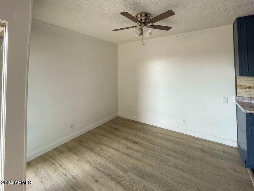 6767 North 7th Street, Unit 227 Phoenix, AZ 85014 - Photo 5 of 11 an empty room with wooden floor and a ceiling fan