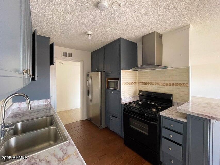 6767 North 7th Street, Unit 227 Phoenix, AZ 85014 - Photo 6 of 11 a kitchen with stainless steel appliances granite countertop a refrigerator and a sink