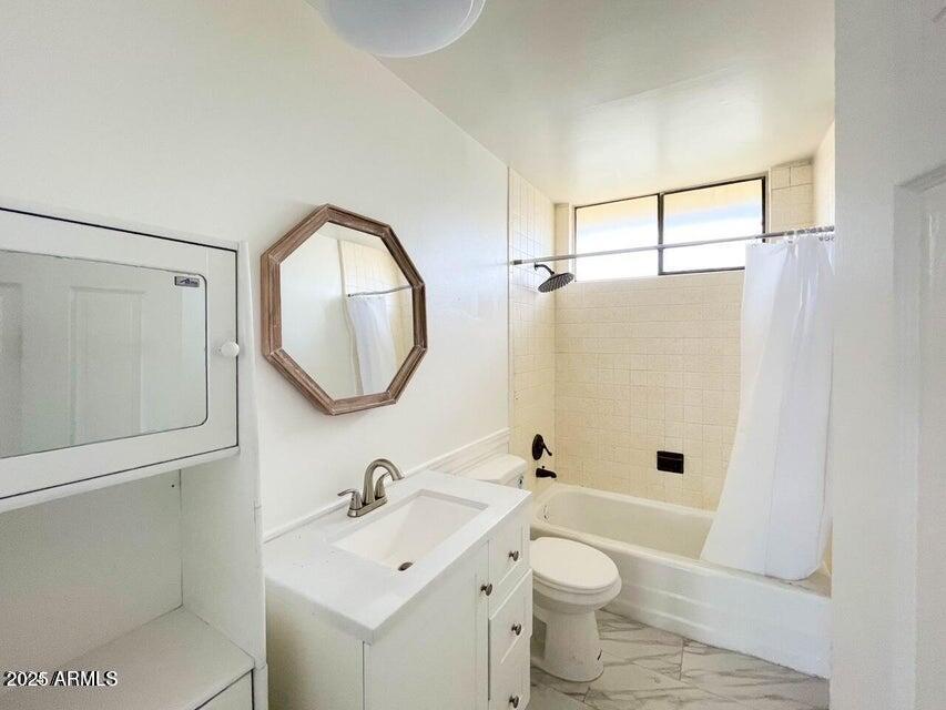6767 North 7th Street, Unit 227 Phoenix, AZ 85014 - Photo 9 of 11 a bathroom with a toilet sink and mirror