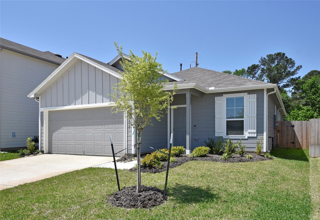 a front view of house with a garden