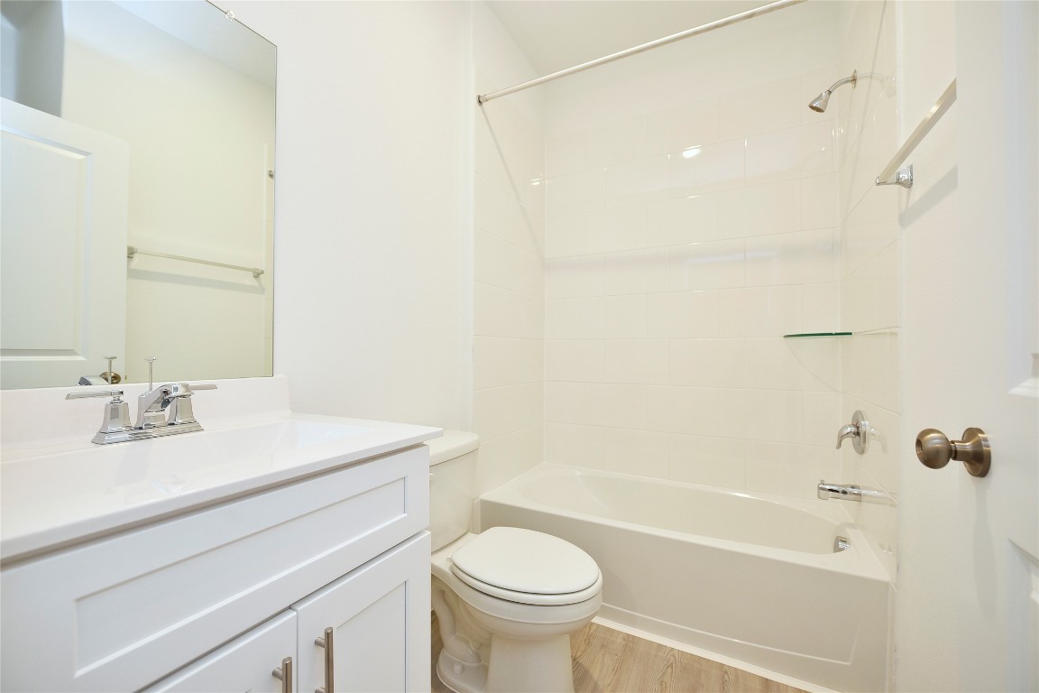 25473 Cilantro Drive Magnolia, TX 77355 - Photo 13 of 21 a bathroom with a sink a toilet and a bathtub