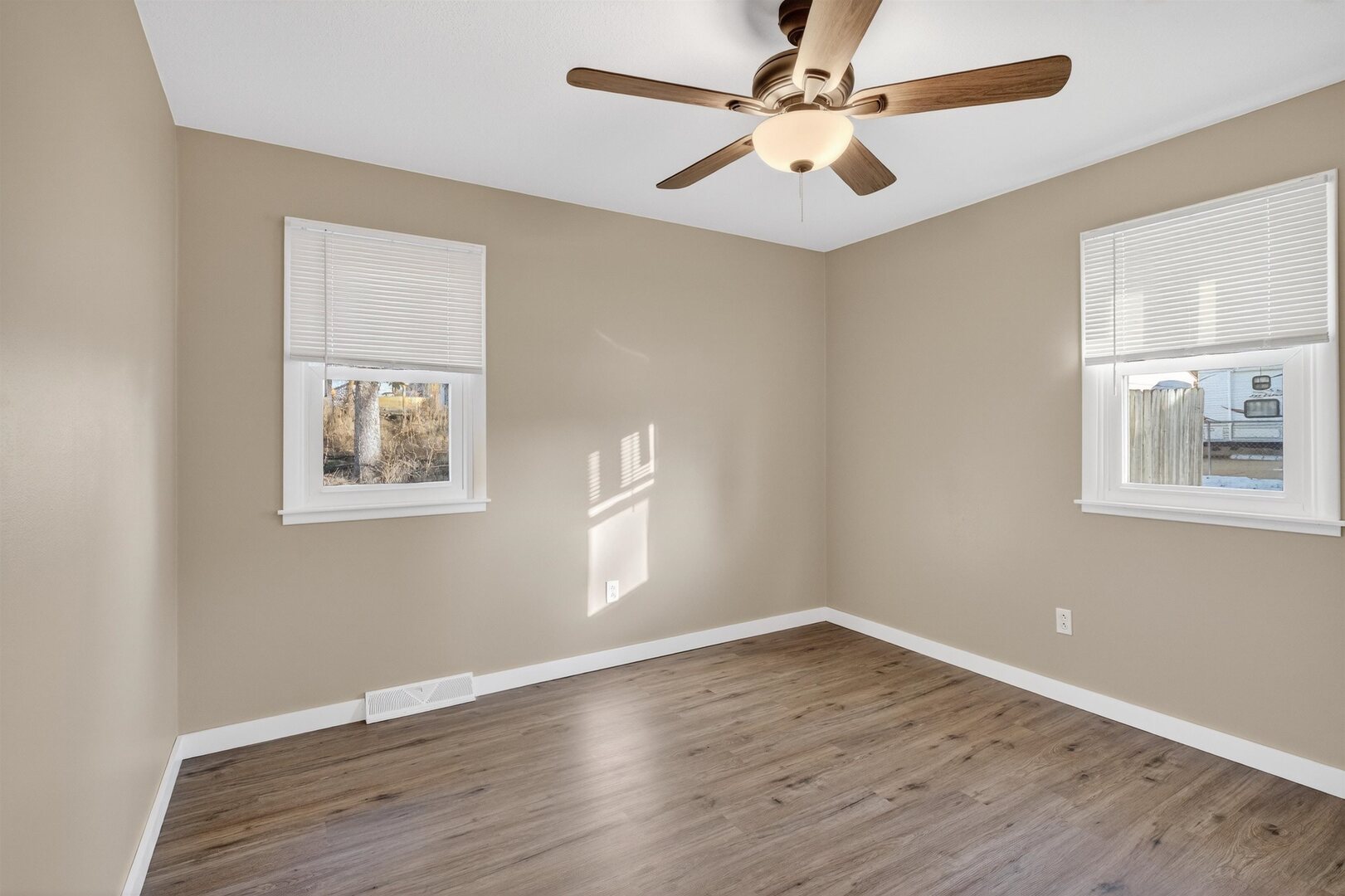 1136 4th Avenue North Clinton, IA 52732 - Photo 19 of 34 a view of an empty room with wooden floor and a window